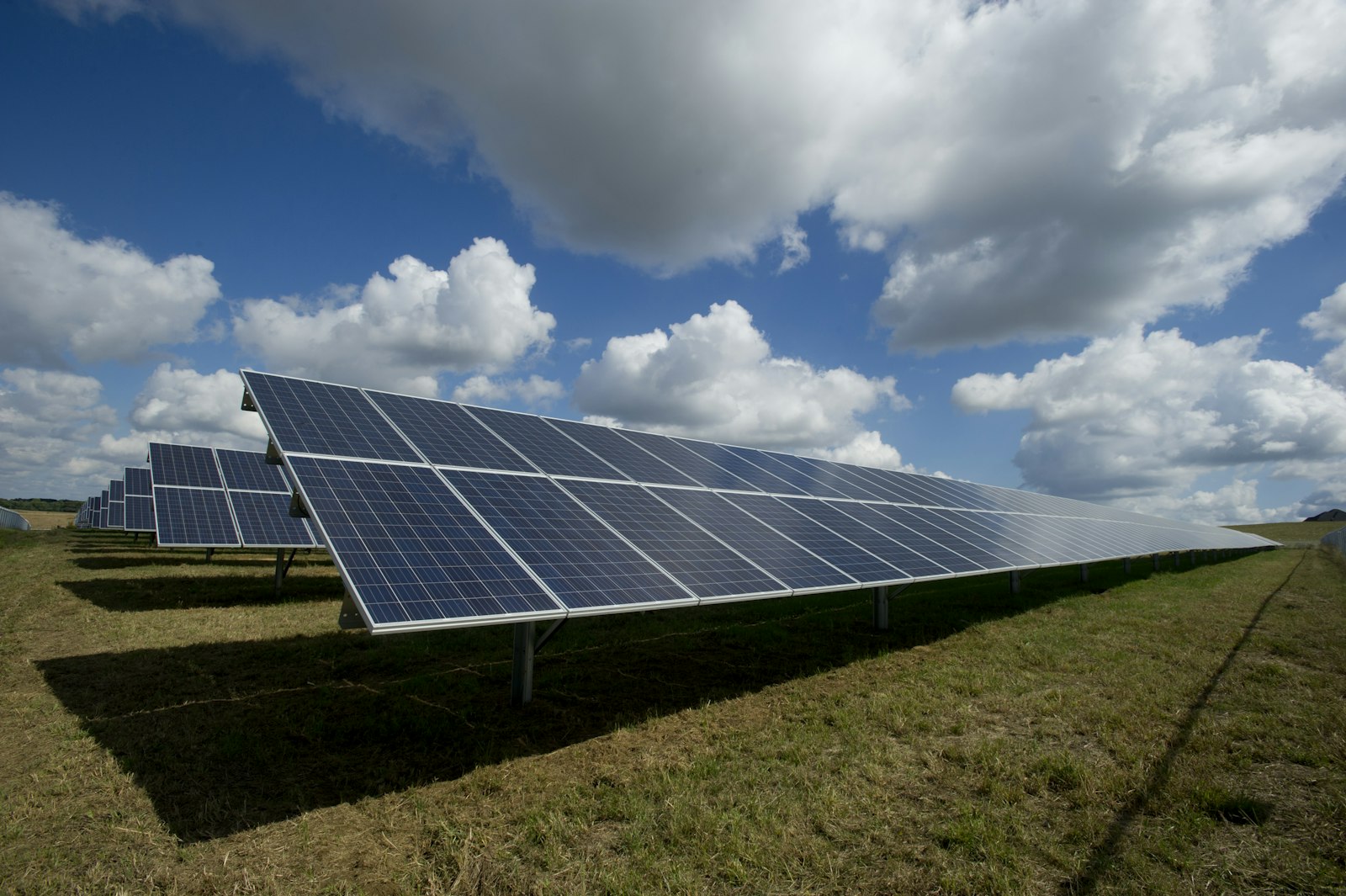 Solar farm panels under blue sky